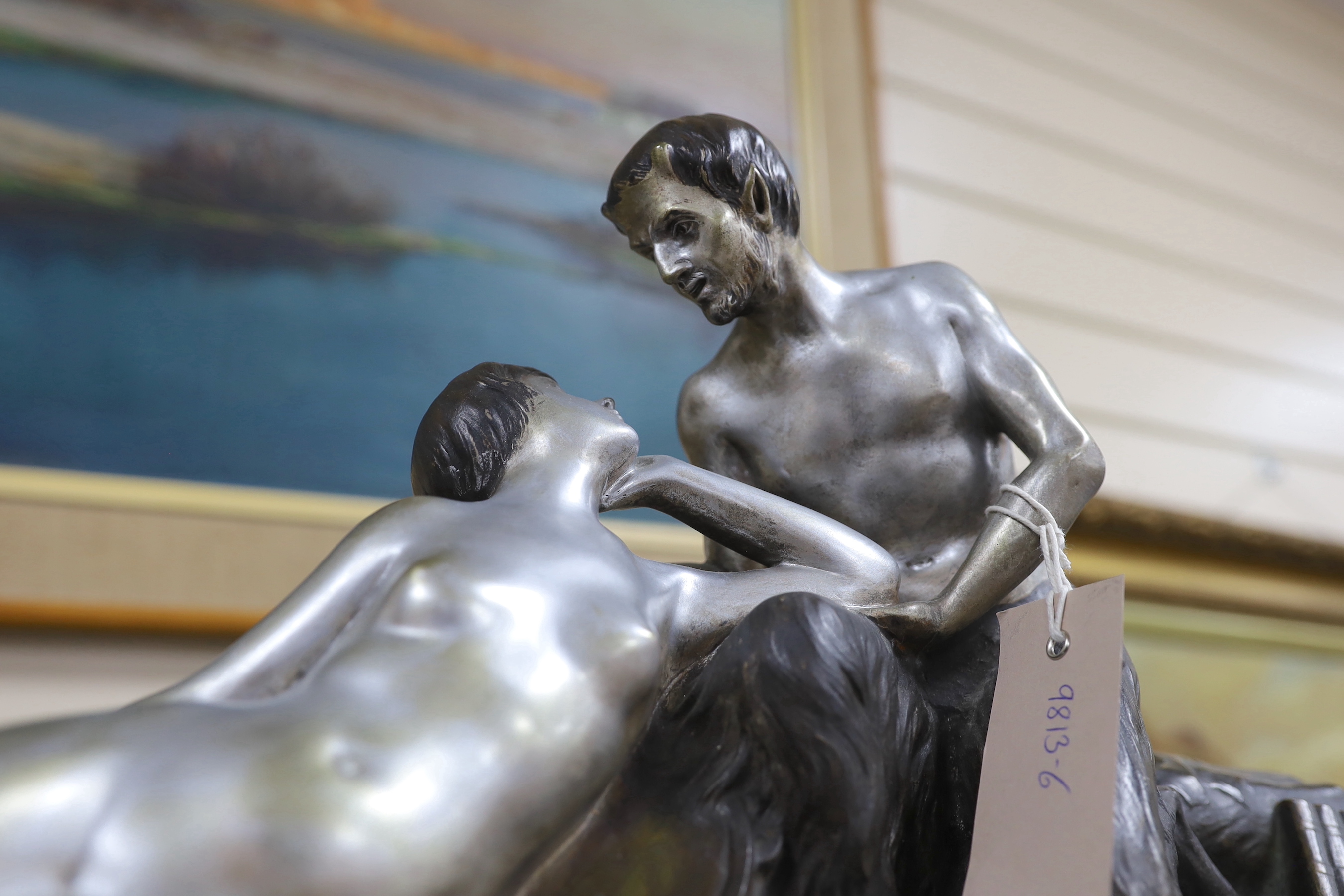 An Art Deco style bronze of a faun and his muse, signed H. Fonquergne, on marble base, 57cm